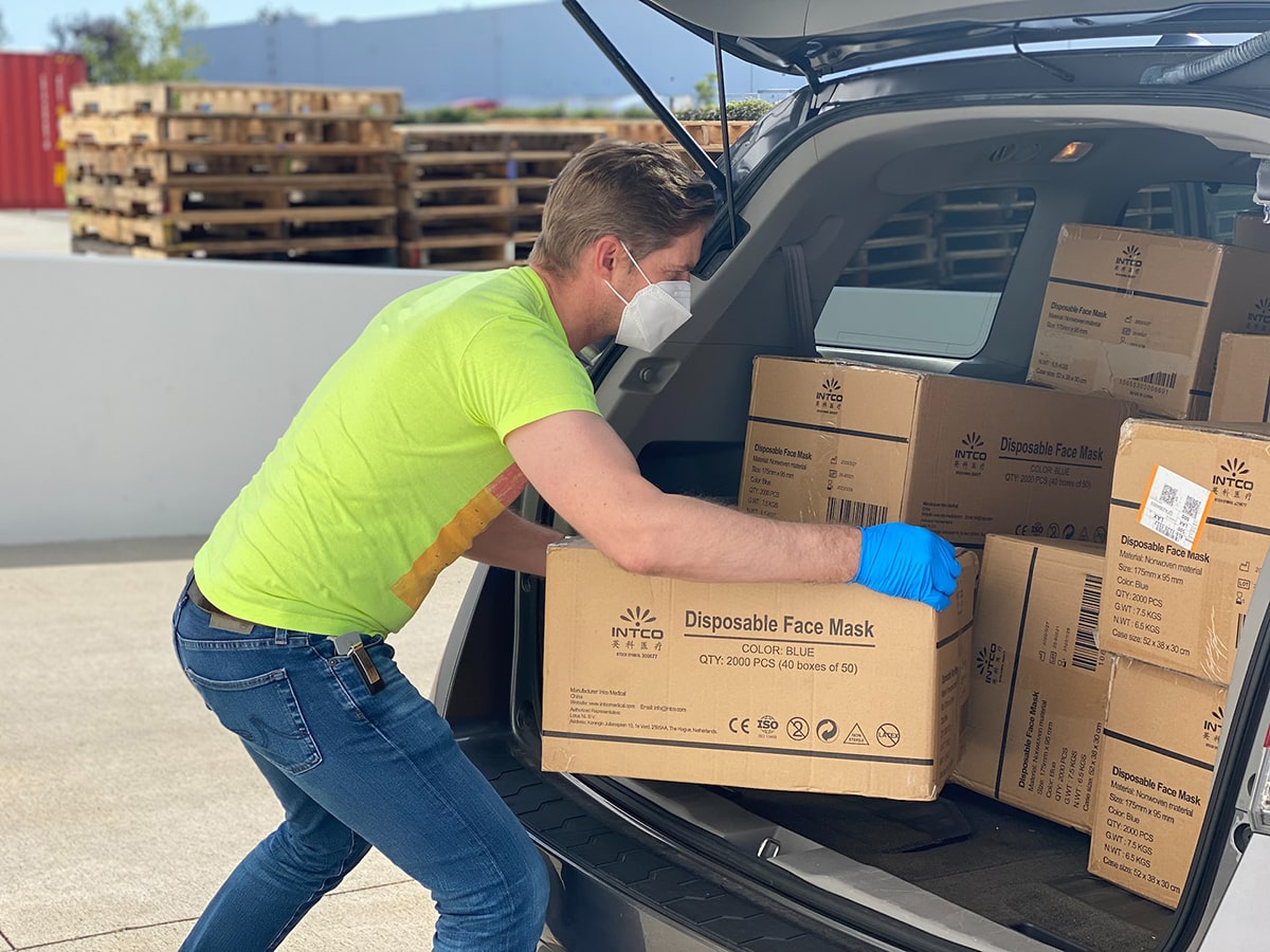 Courier guy putting boxes in van - Betachon Freight Auditing