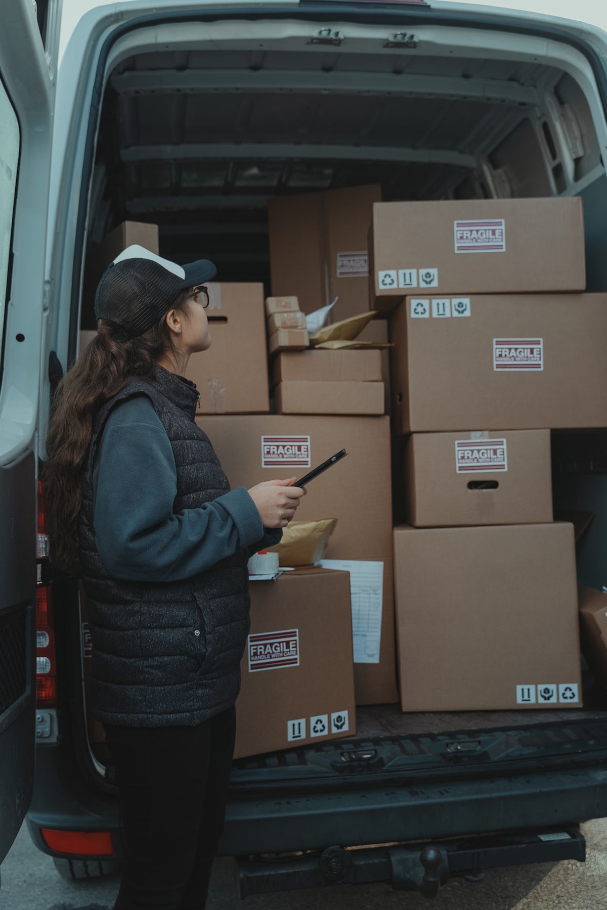 Woman shipping boxes in shipping van